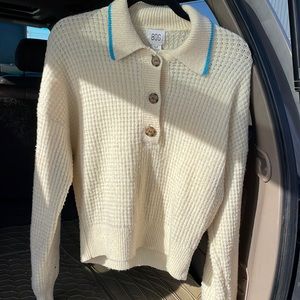 BDG knit sweater. Cream color with brown buttons and blue lining at colar